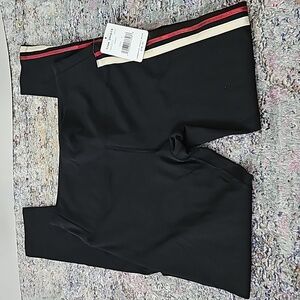 Free People Movement New leggings. Black with a red and gold stripe down. SIZE S